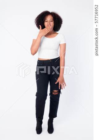 Full body shot of young beautiful African woman looking shocked Full body shot of young beautiful African woman looking shocked 57716952