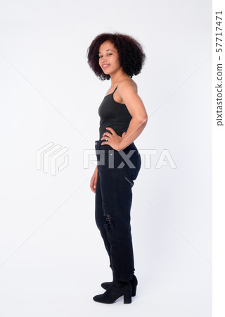 Full body shot profile view of happy young beautiful African woman smiling 57717471