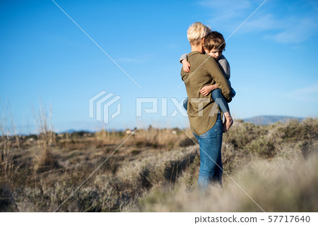Young mother with small daughter walking in mediterranean nature. 57717640