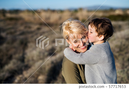 Young mother with small daughter in mediterranean nature, kissing. Young mother with small daughter in mediterranean nature, kissing. 57717653