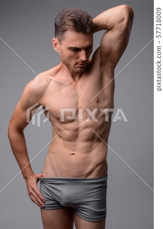 Studio shot of handsome muscular man shirtless Studio shot of handsome muscular man shirtless 57718009