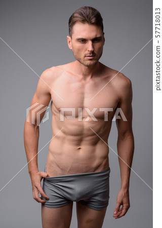 Studio shot of handsome muscular man shirtless Studio shot of handsome muscular man shirtless 57718013