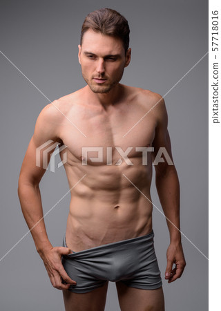 Studio shot of handsome muscular man shirtless Studio shot of handsome muscular man shirtless 57718016