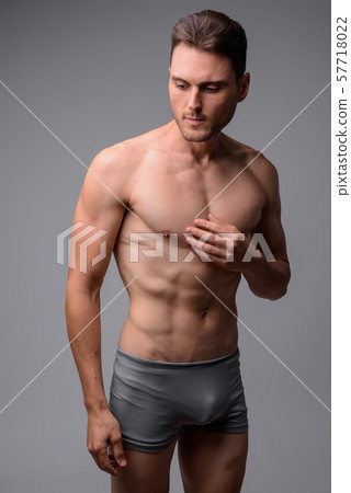 Studio shot of handsome muscular man shirtless 57718022