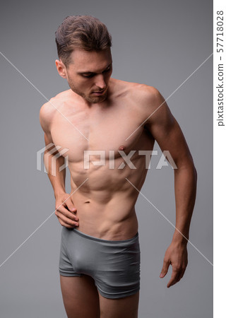 Studio shot of handsome muscular man shirtless 57718028