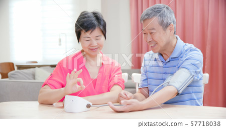 elder couple use blood manometer 57718038