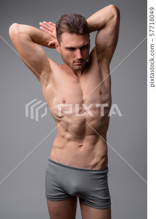 Studio shot of handsome muscular man shirtless 57718049