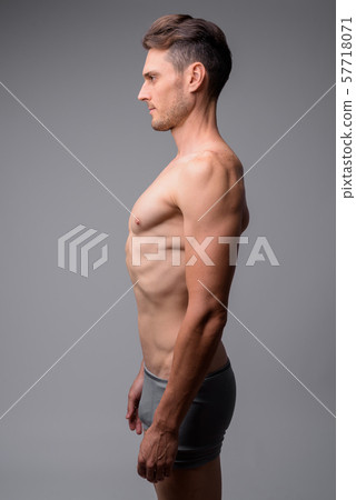 Studio shot of handsome muscular man shirtless - Stock Photo