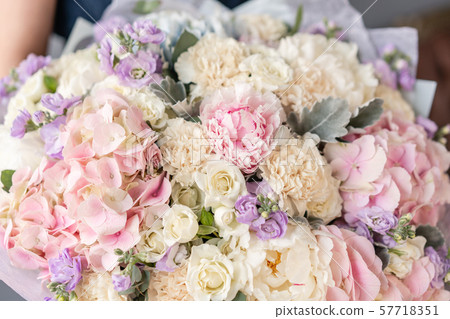 Large Beautiful bouquet of mixed flowers in woman hand. Floral shop concept . Beautiful fresh cut Large Beautiful bouquet of mixed flowers in woman hand. Floral shop concept . Beautiful fresh cut 57718351