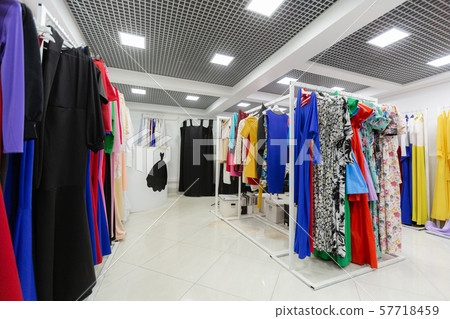 Clothing store with lots of dresses on hangers 57718459