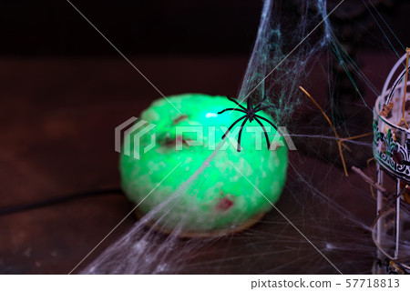 Witch green lamp ball with candles and cobwebs on a black background. Halloween party 57718813