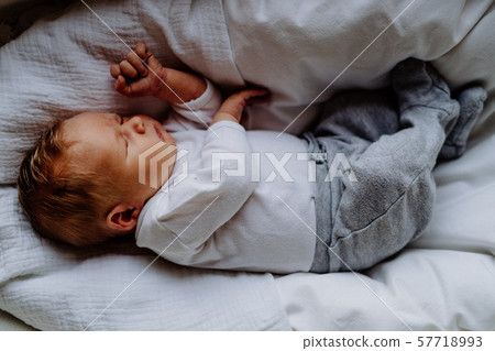 A close-up of a sleeping newborn baby at home., top view. A close-up of a sleeping newborn baby at home., top view. 57718993