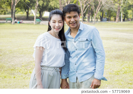 Adult male and female couples in the park. Adult male and female couples in the park. 57719069