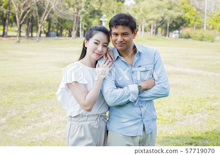 Adult male and female couples in the park. Adult male and female couples in the park. 57719070