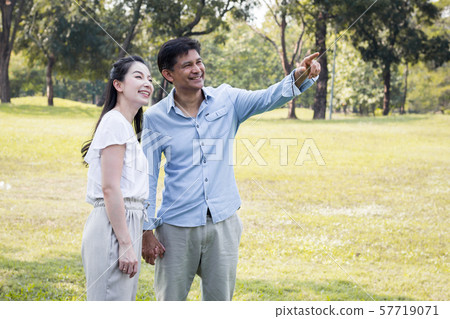 Adult male and female couples in the park. Adult male and female couples in the park. 57719071
