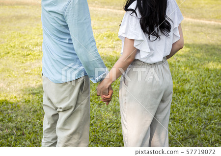 Adult male and female couples in the park. 57719072
