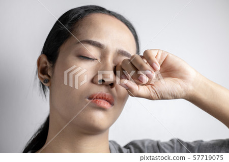 Woman suffering from strong eye pain. Woman suffering from strong eye pain. 57719075