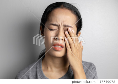 Woman suffering from strong eye pain. Woman suffering from strong eye pain. 57719078