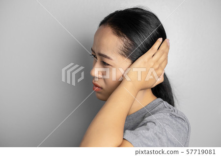 Young woman is suffering of earache. Young woman is suffering of earache. 57719081