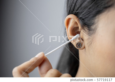 Concept of cleaning in the ear hole. Concept of cleaning in the ear hole. 57719117