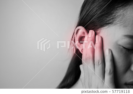 Young woman is suffering of earache. 57719118
