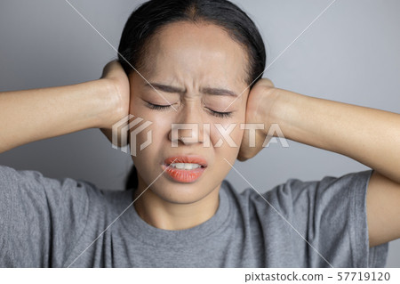 Young woman is suffering of earache. Young woman is suffering of earache. 57719120