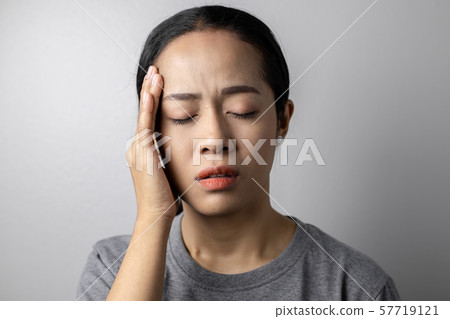 Young woman with of stress and headaches. 57719121