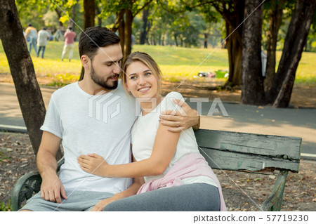 Couples sitting and hugging in the park. Couples sitting and hugging in the park. 57719230