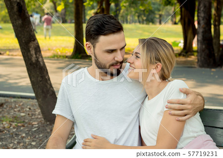Couples sitting and hugging in the park. Couples sitting and hugging in the park. 57719231