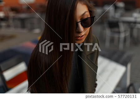 Portrait of a stylish and young brunette girl Portrait of a stylish and young brunette girl 57720131