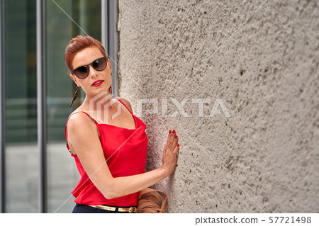Portrait of a red-haired middle-aged woman Portrait of a red-haired middle-aged woman 57721498