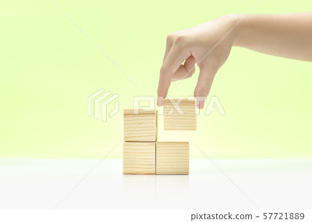 Hand build a stack of wooden block toy 57721889