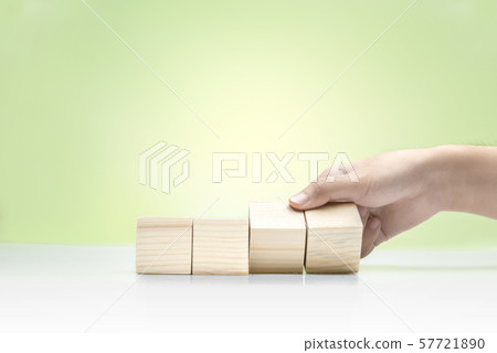 Hand playing with wooden block on the table 57721890