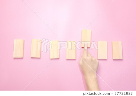 Hand playing with wooden block toy Hand playing with wooden block toy 57721982