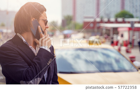 Photo of stylish brunet talking on phone near yellow car in city 57722358