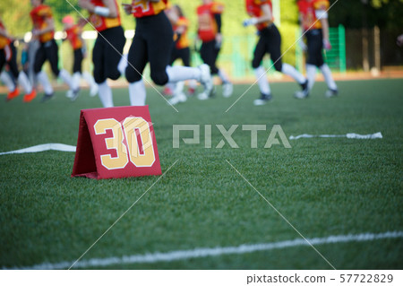 Photo of soccer field with number thirty running football players on blurred background Photo of soccer field with number thirty running football players on blurred background 57722829