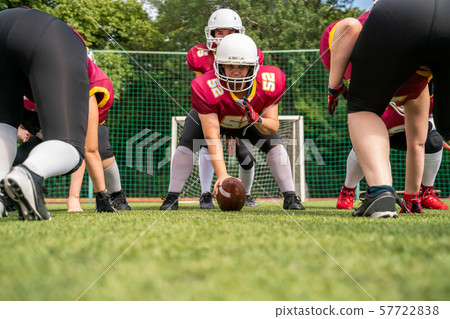 Photo of sportive women playing american football on green lawn Photo of sportive women playing american football on green lawn 57722838