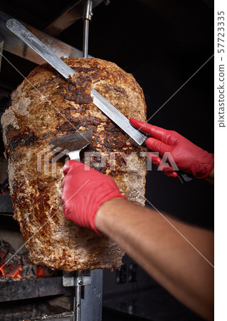 Fried meat on a skewer for cooking of donors or shawarma. Close-up 57723335