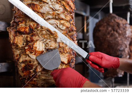 Fried meat on a skewer for cooking of donors or shawarma. Close-up 57723339
