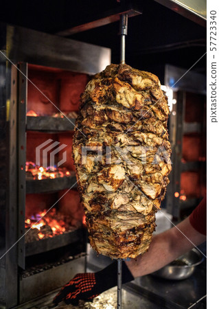 Close up shot of stacked meat roasting to be used in preparation of traditional Greek dish gyros or 57723340