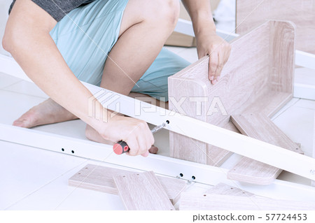 Young Asian Man Assembling shelves 57724453