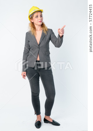 Full body shot of blonde businesswoman as engineer directing and pointing finger 57724455