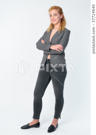 Full body shot of happy beautiful blonde businesswoman with arms crossed 57724640