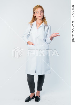 Full body shot of beautiful blonde woman doctor talking Full body shot of beautiful blonde woman doctor talking 57724683