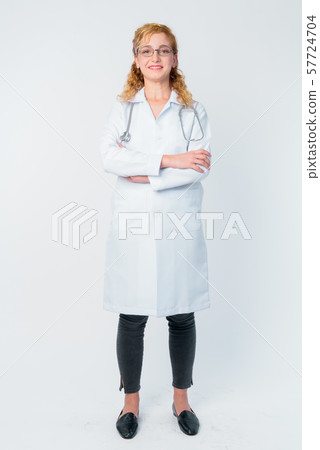 Full body shot of happy blonde woman doctor smiling with arms crossed Full body shot of happy blonde woman doctor smiling with arms crossed 57724704