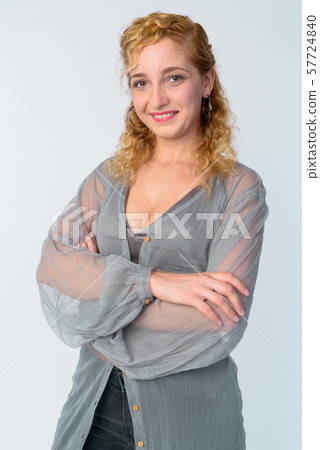 Portrait of happy beautiful blonde woman smiling with arms crossed Portrait of happy beautiful blonde woman smiling with arms crossed 57724840