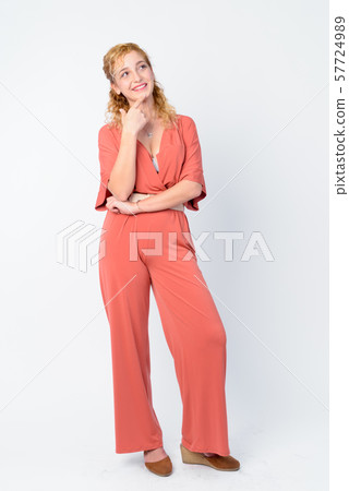 Full body shot of happy beautiful blonde woman thinking and looking up Full body shot of happy beautiful blonde woman thinking and looking up 57724989