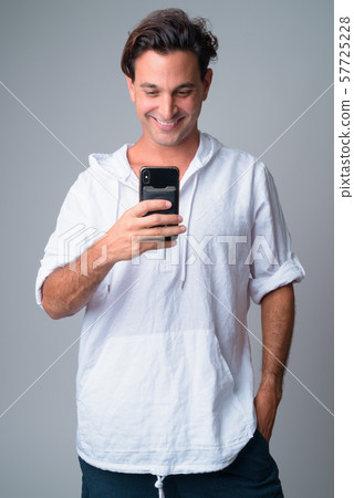 Portrait of happy handsome Hispanic man taking picture with phone Portrait of happy handsome Hispanic man taking picture with phone 57725228