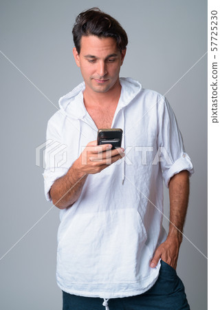 Portrait of handsome Hispanic man using phone Portrait of handsome Hispanic man using phone 57725230
