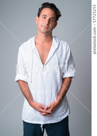 Portrait of handsome Hispanic man wearing hooded shirt 57725255